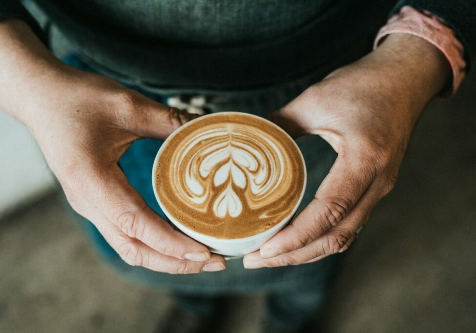 Image of a cup of coffee being held by a person