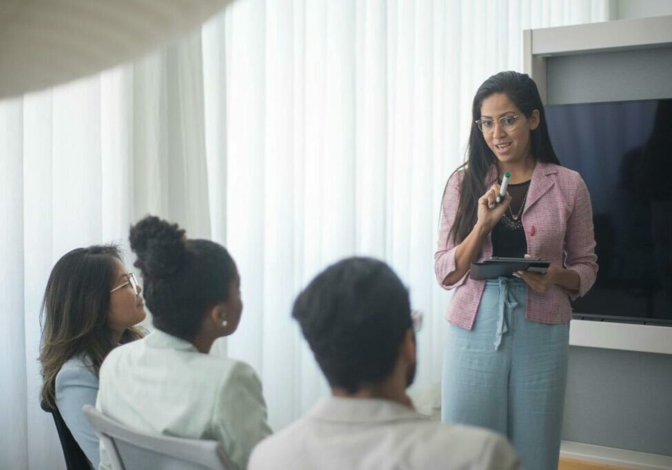 Image of a woman teaching three youth